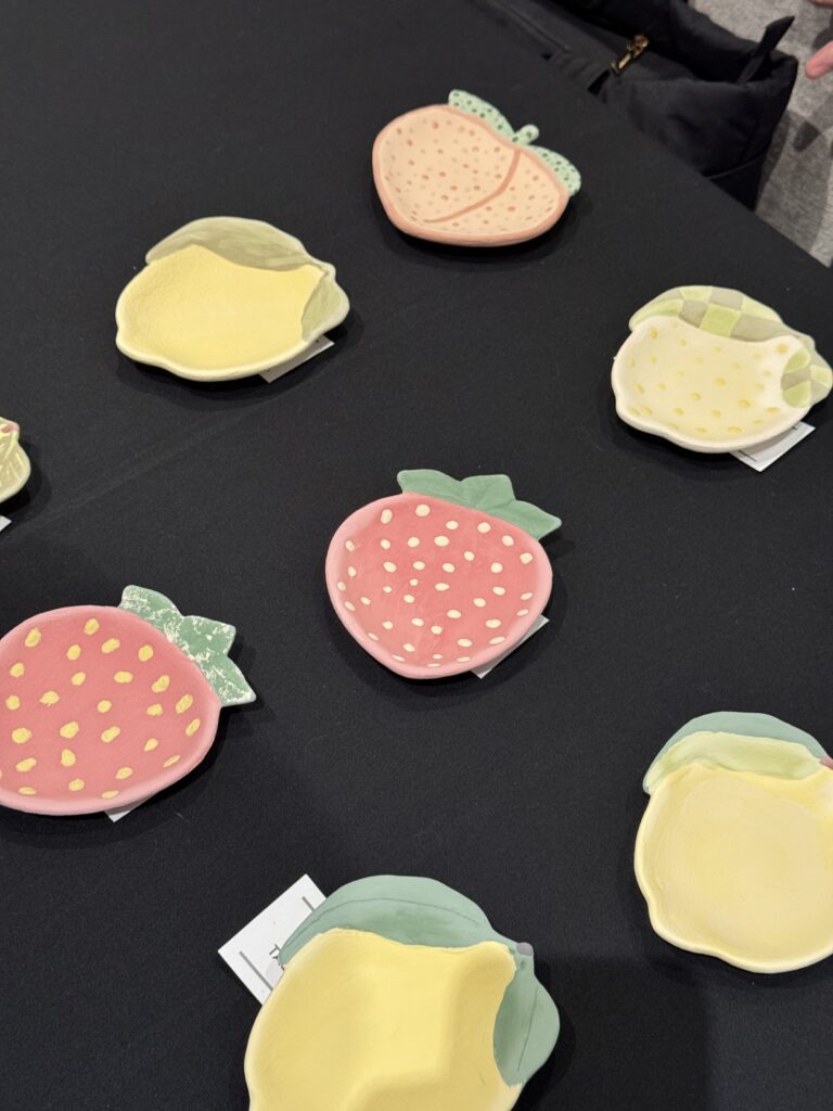 Small pottery pieces shaped like a peach, lemon, or strawberry from Arts A Blaze, a craft studio in Sarasota, Florida