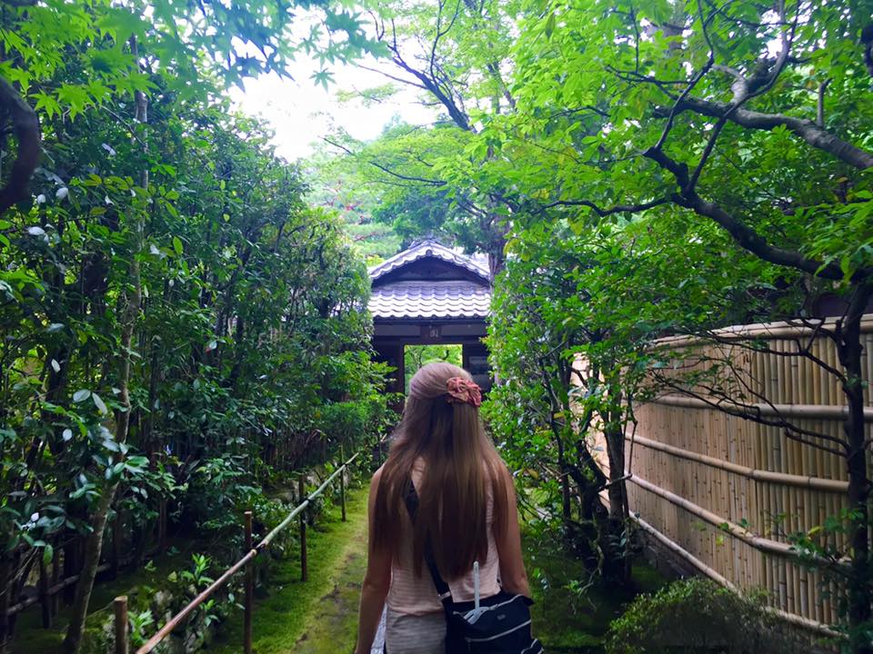 Woman standing on a path surrounded by greenery (Koto-in Temple in Kyoto)