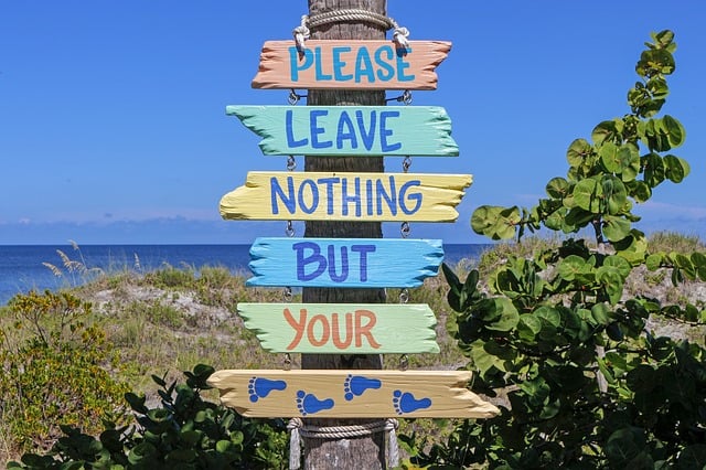 Beach sign that says "please leave nothing but your footprints." | Beach checklist - packing tips for the beach