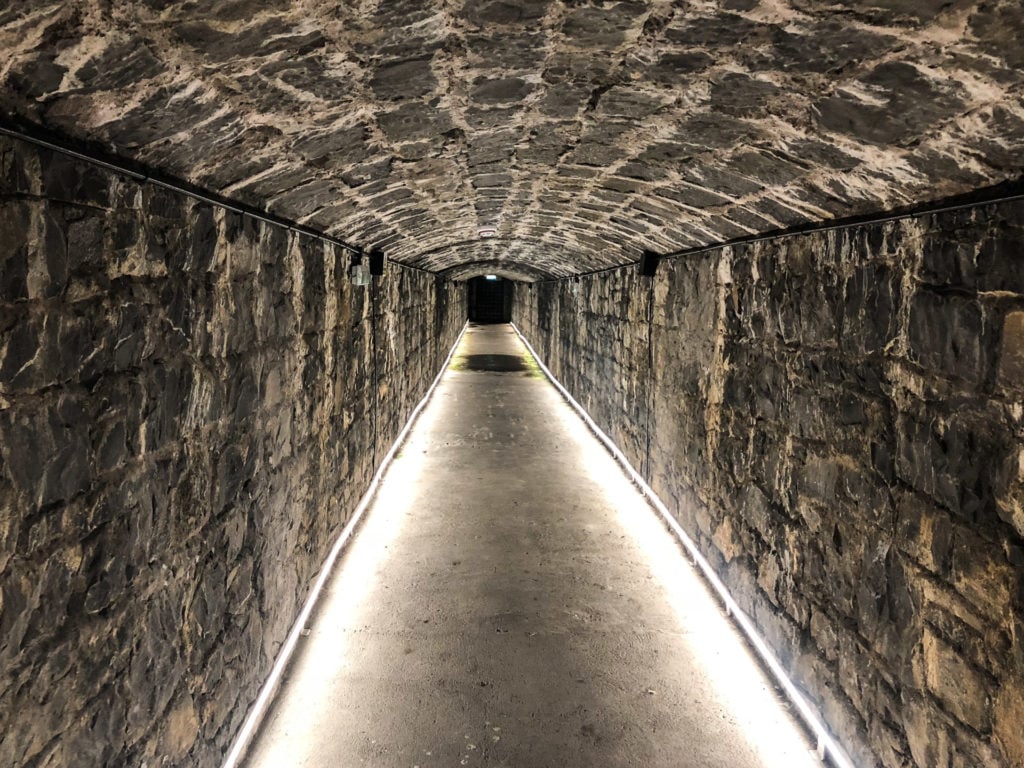 Lit up underground tunnel leading to a wine cellar in Ashford Castle