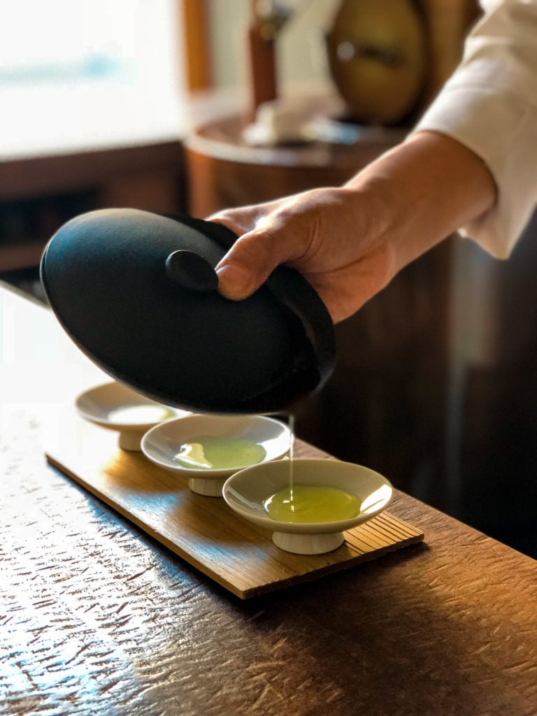 Hand pouring green tea at YOROZU - Fukuoka