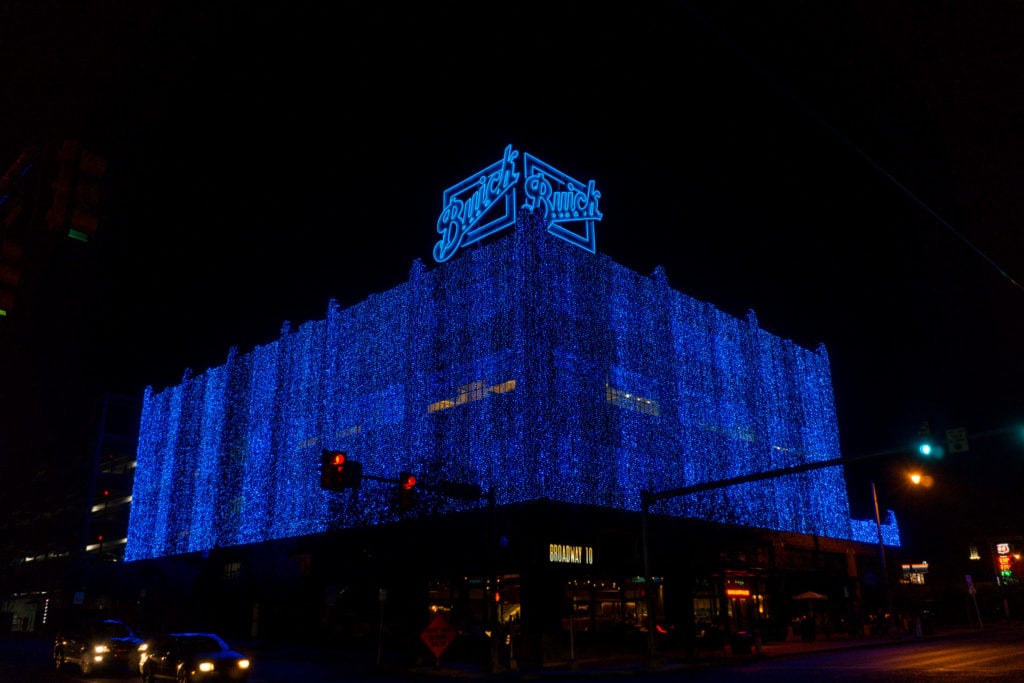 Blue holiday lights on brick building in Automobile Alley OKC