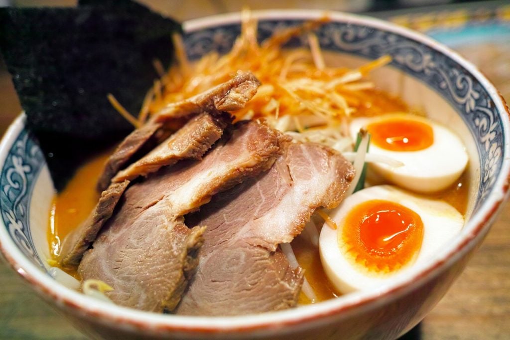 Bowl of ramen with pork, seaweed, and egg.