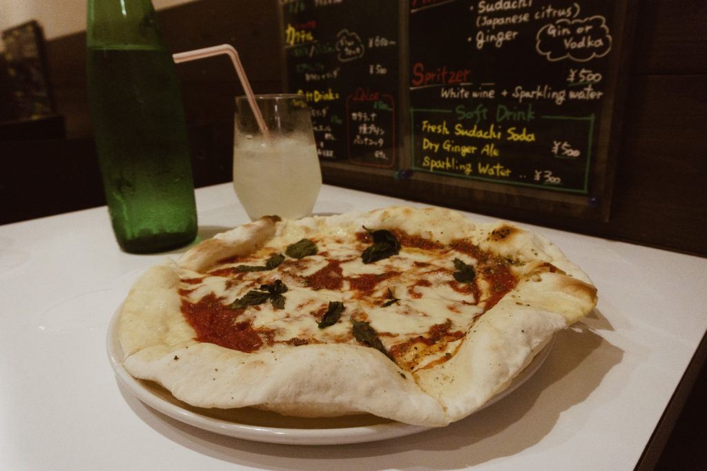 Personal size margherita pizza with a lemonade drink in the background from Parco in Nara, Japan