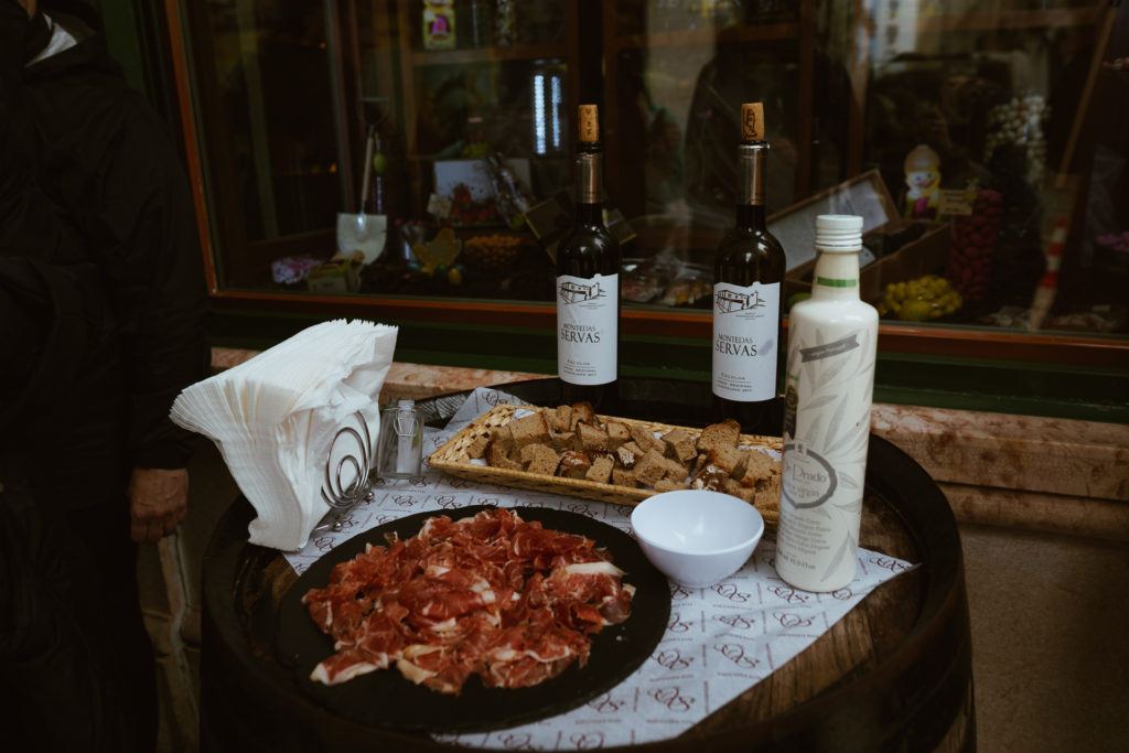 Sampling of bread, cheese,  cured ham, and wine from the Taste of Lisboa food tour