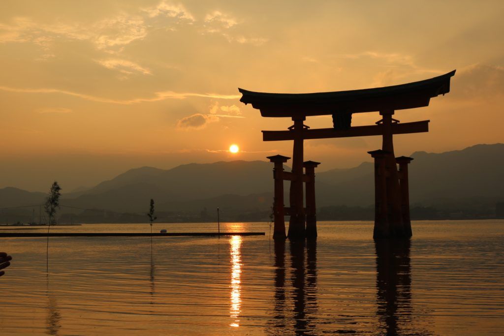 How to start travel hacking post - image of Miyajima floating torii gate in Japan