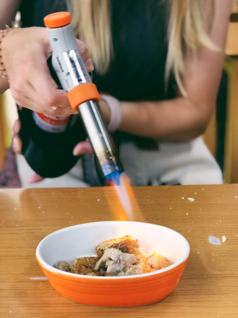 Charring chicken with a blowtorch at Ramen Factory Kyoto