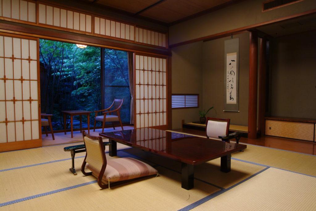 View of the garden area and open-air bath from the living space in the Hatsune Room at  Nishimuraya Honkan.