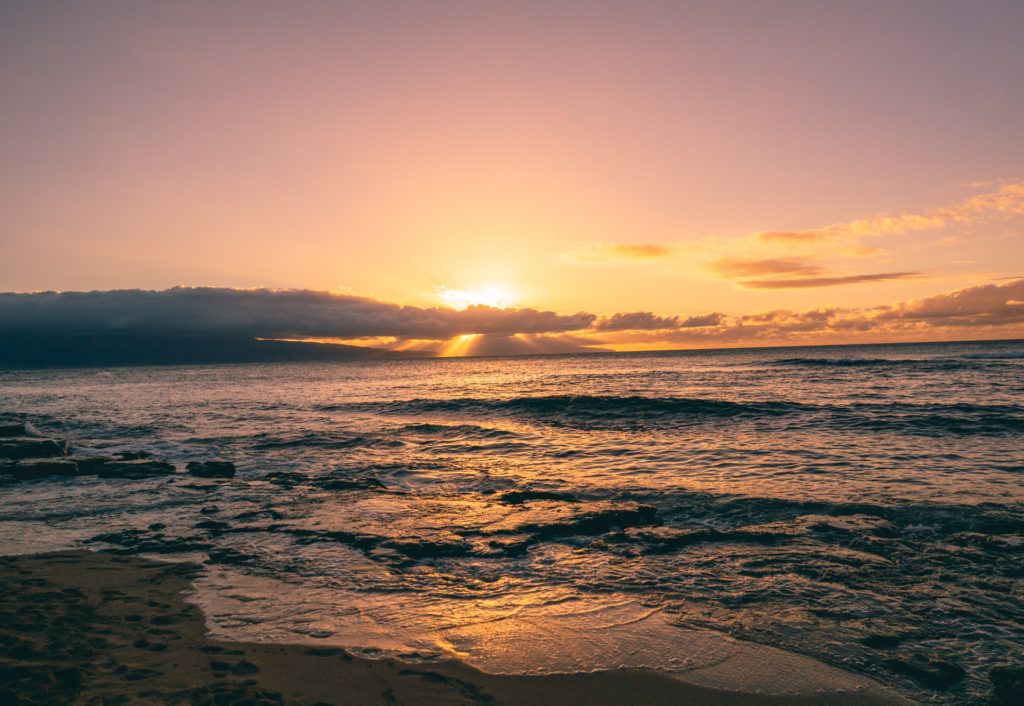 Sunset on a beach in Maui. (A 7 day Maui itinerary)