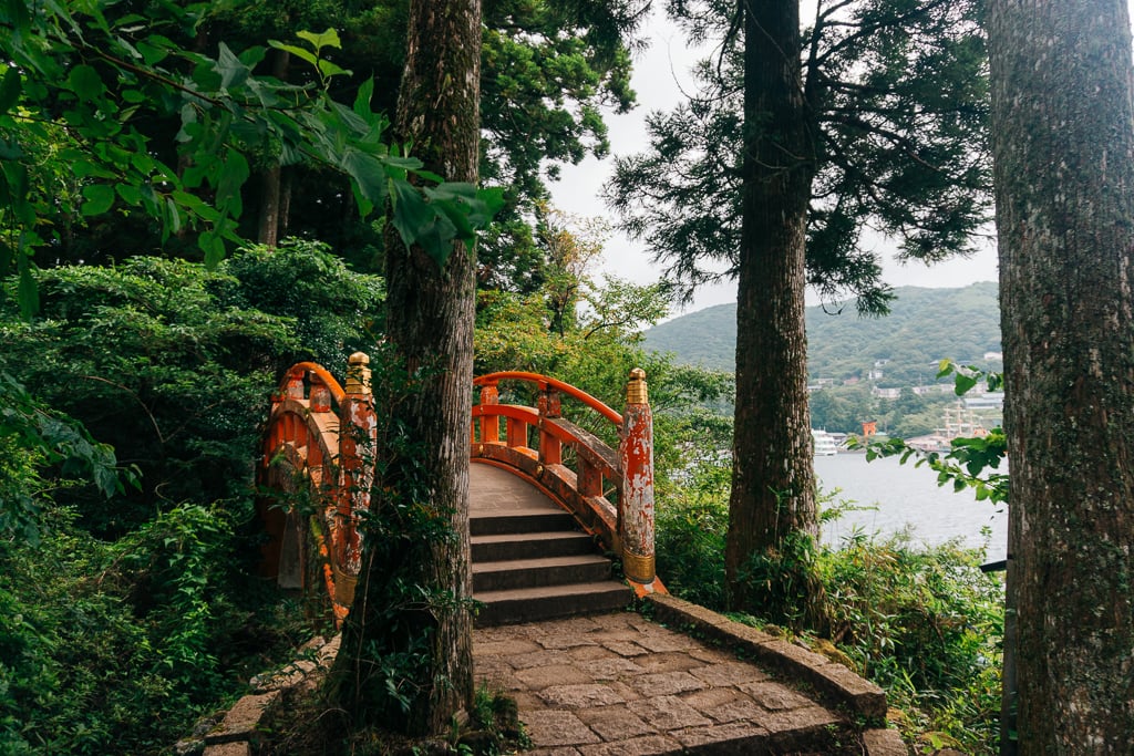 Vermillion bridge in Hakone on stone path