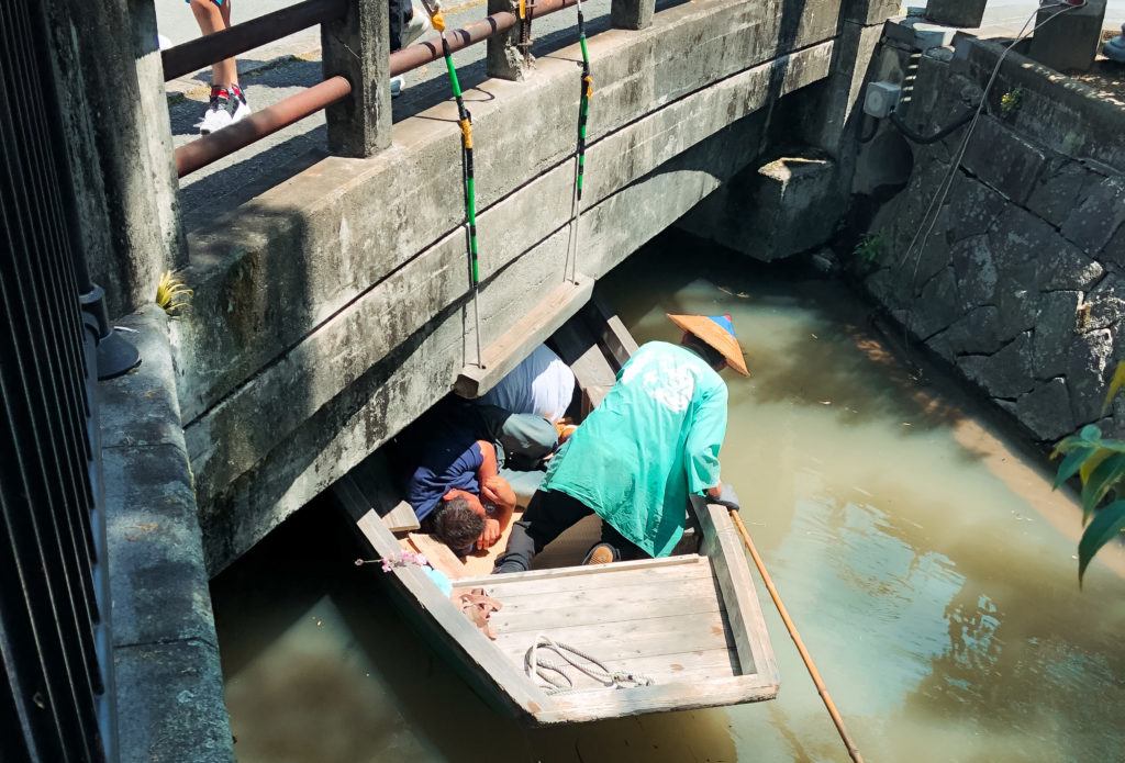 Ducking under a bridge on a boat in Yanagawa