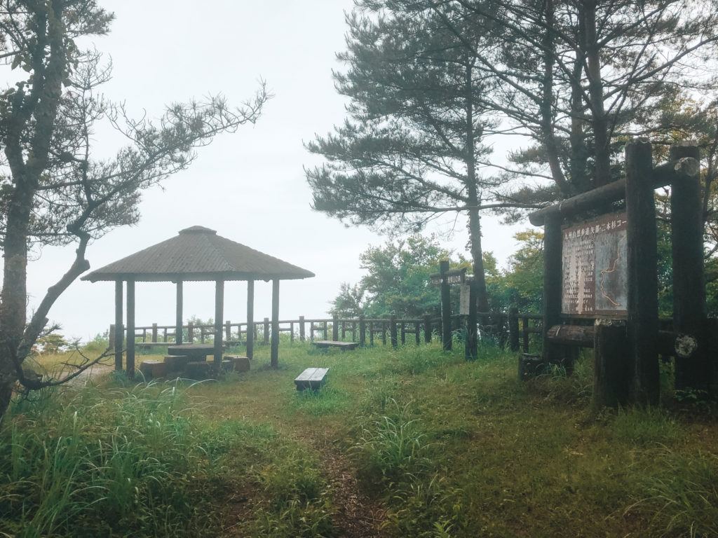 Pavilion and map of hiking trail at Nihonsugi Toge Mountain Pass in Gokanosho, Japan