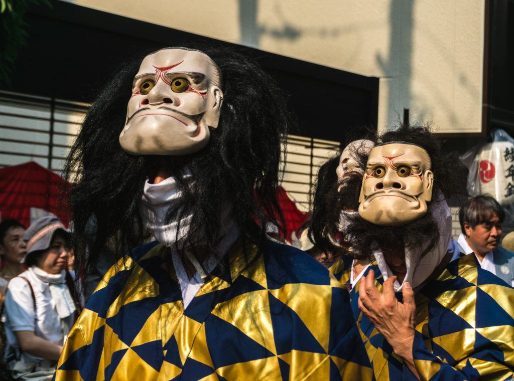 Men wearing masks at Gion Matsuri - Kyoto