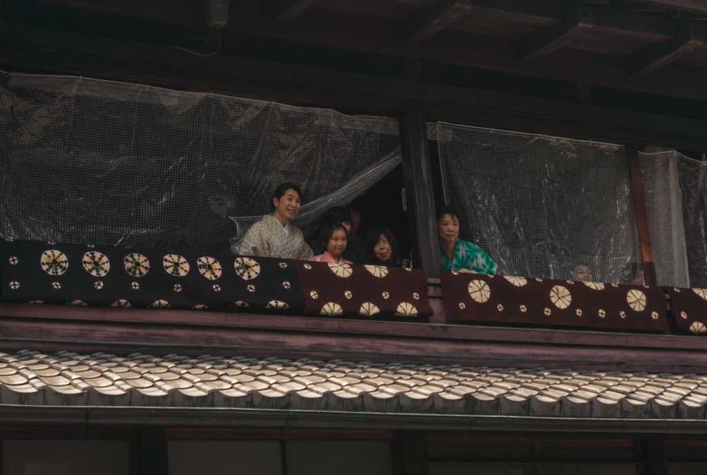 People waving from their home in Gion, Kyoto