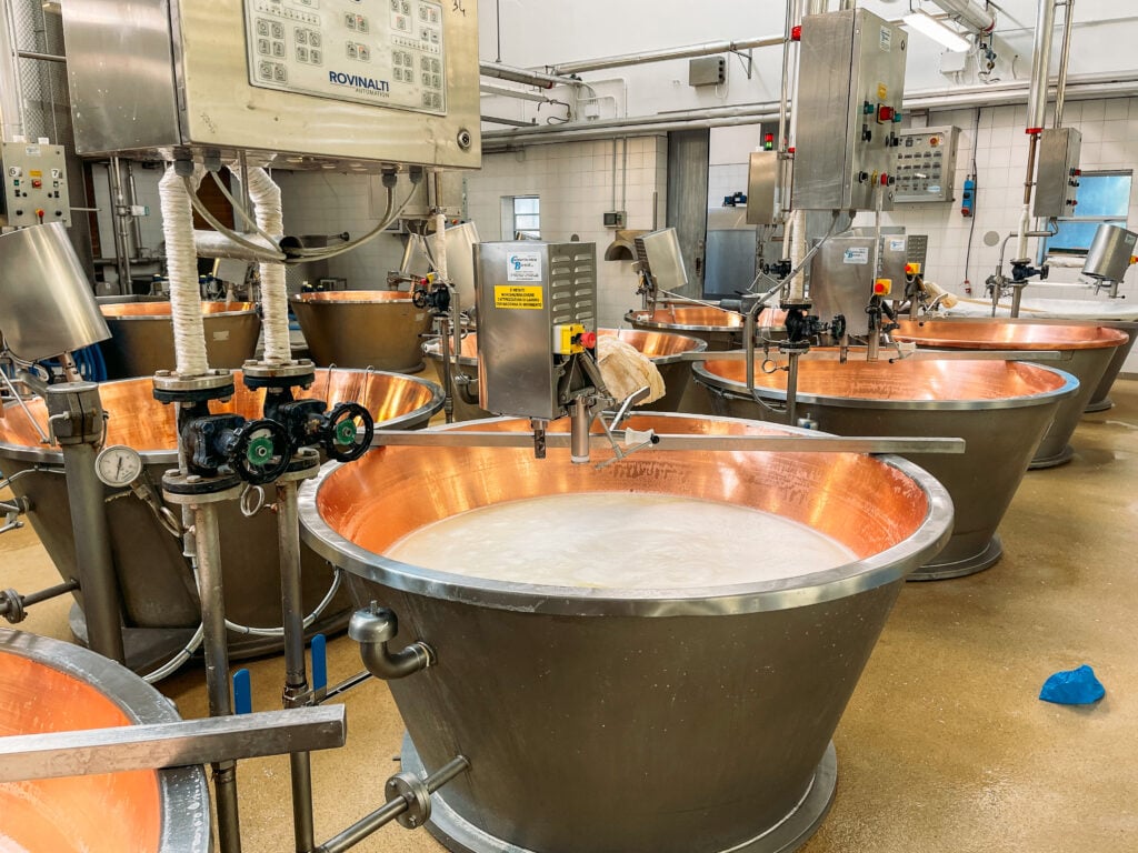 Vats used for processing the parmesan cheese at the factory. Italian Days Food Tour in Bologna.