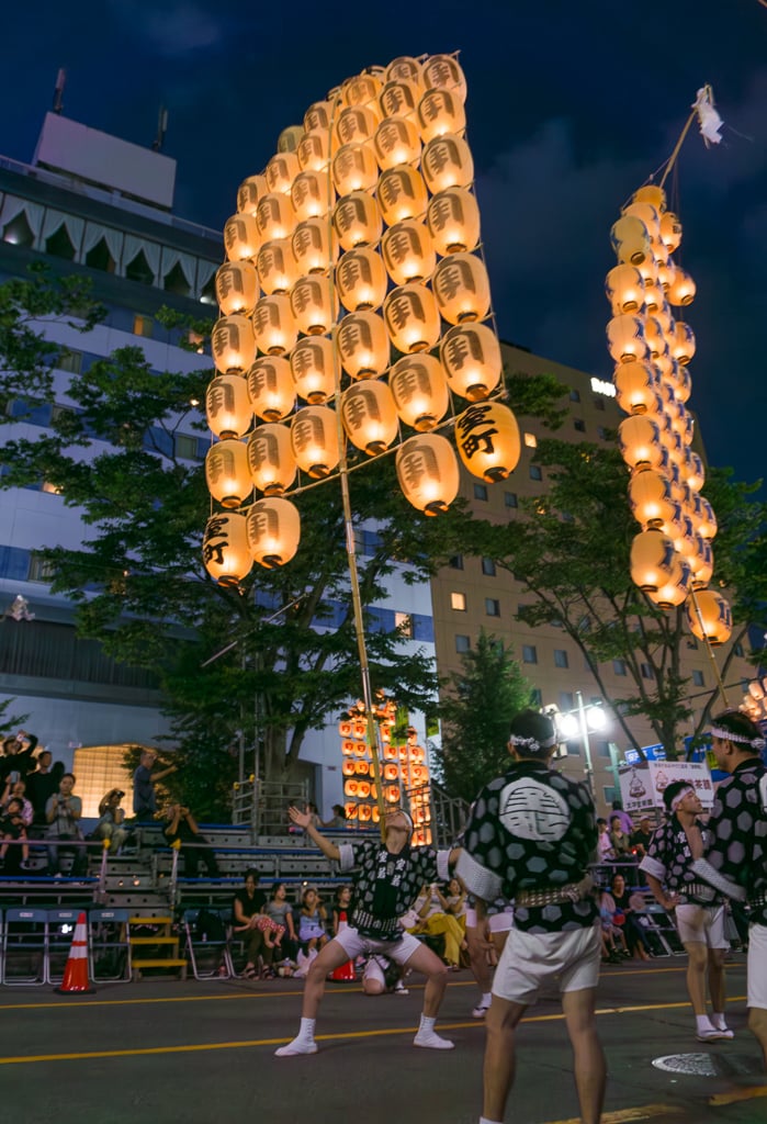 Balancing kanto poles with lanterns at Akita Kanto Matsuri in Japan