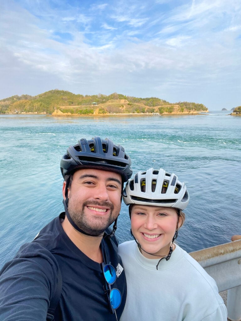 Selfie of two people in front of one of the Naruto Whirlpools on Shimanami Kaido.