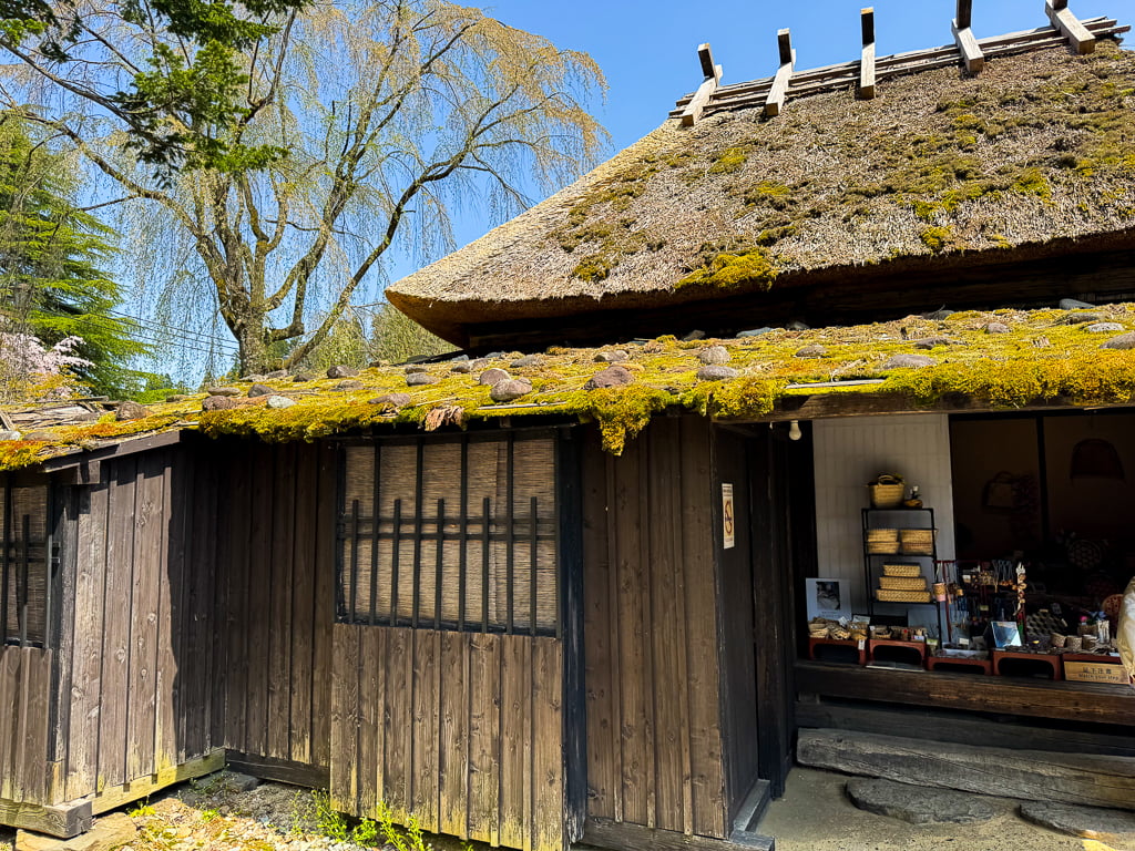 The outside of Matsumoto-ke Samurai house in Kakunodate, Japan. It has a thatched roof and open air shop.